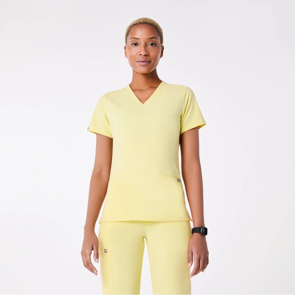 FIGS Women’s Three-Pocket Scrub Top in color Sunlight
